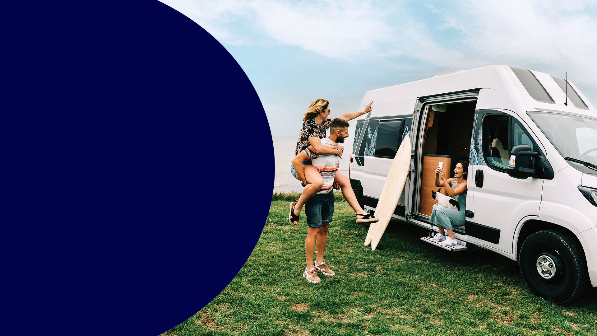 A group of young people having fun in and around a camper van