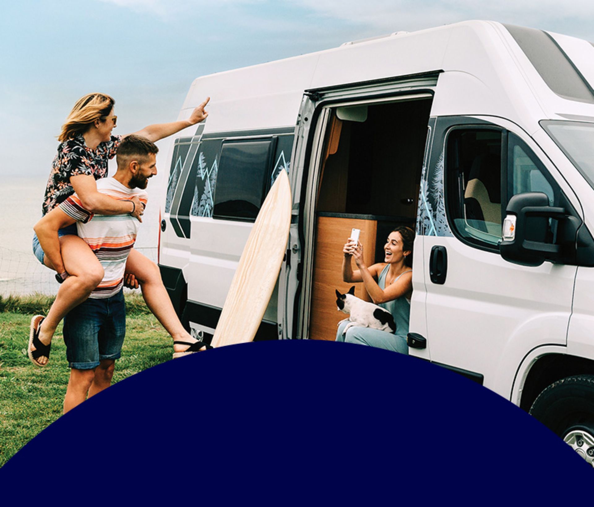 A group of young people having fun in and around a camper van